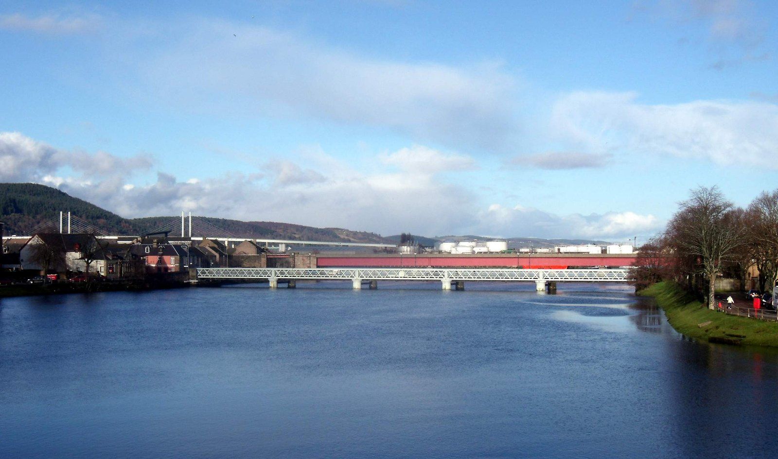 The River Ness in Inverness seen from Friars Bridge, with buildings and bridges along the water